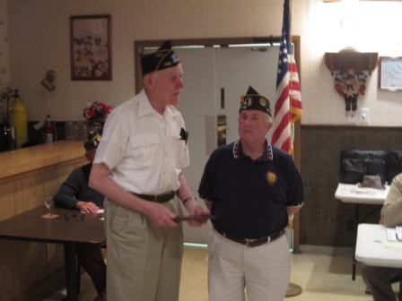 Walt Harrison accepts plaque as Legionnaire of the Year